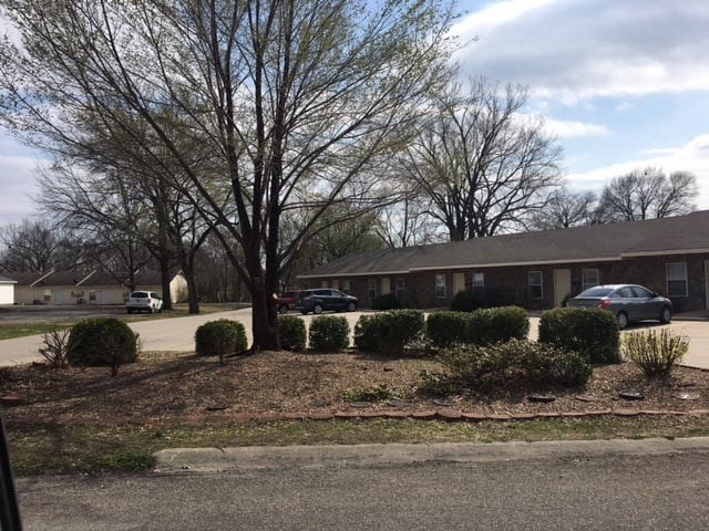 a house in a neighborhood with a tree in front of it