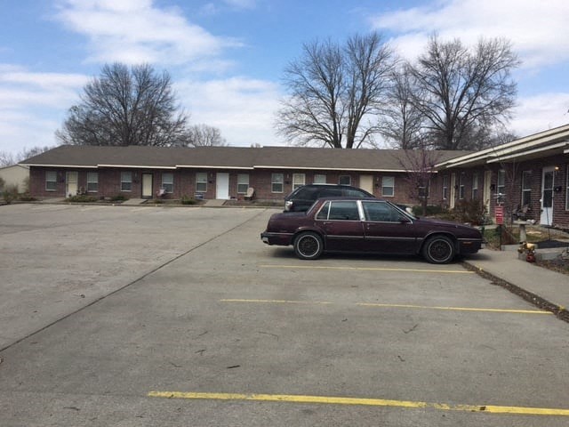 a car parked in a parking lot in front of a building