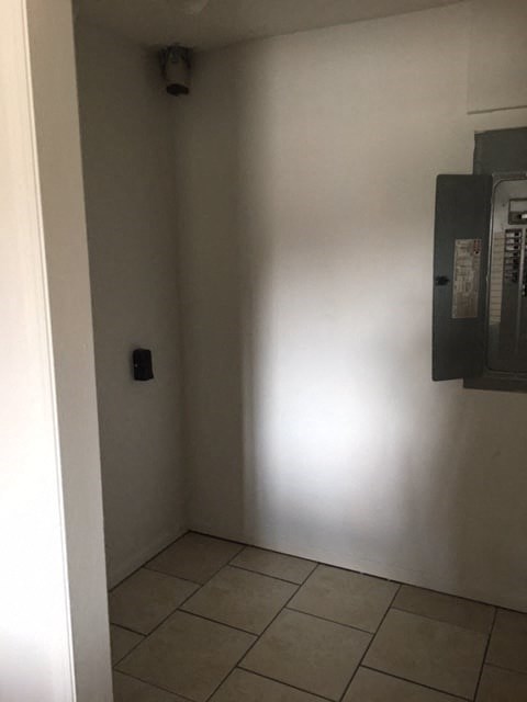 a room with a wall and a microwave in it