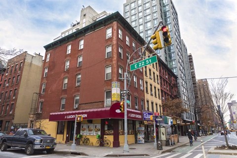 a building on the corner of a city street with a traffic light