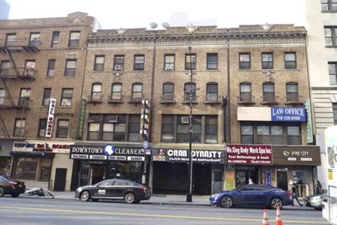 A street view of a building with a law office on the top floor.