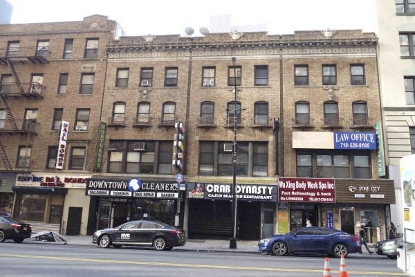 two cars parked in front of a building on a city street