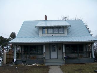 a house with a tin roof and a porch
