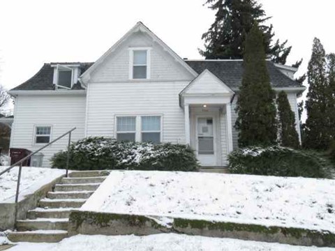 a white house with snow on the ground