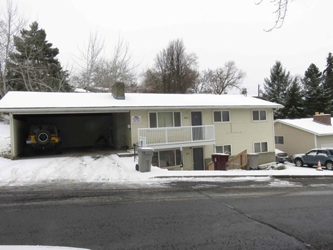 A house with a garage covered in snow.