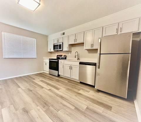 a kitchen with stainless steel appliances and white cabinets