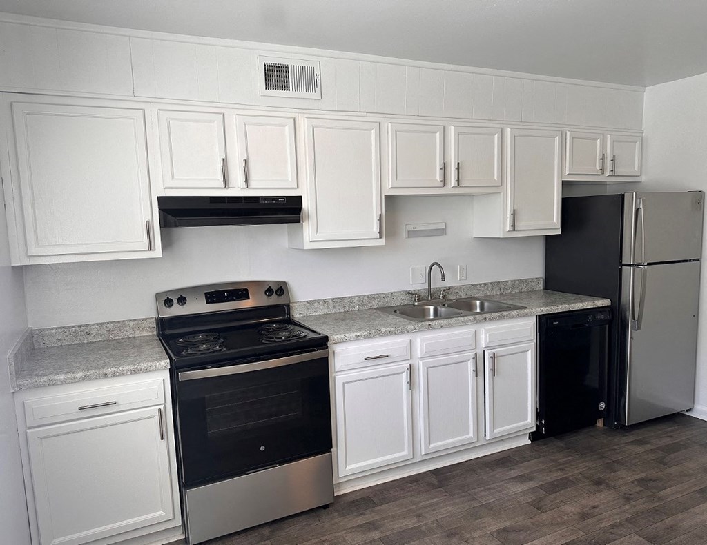 a kitchen with white cabinets and a black stove and refrigerator