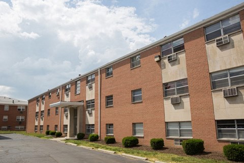 a brick apartment building with a street in front of it