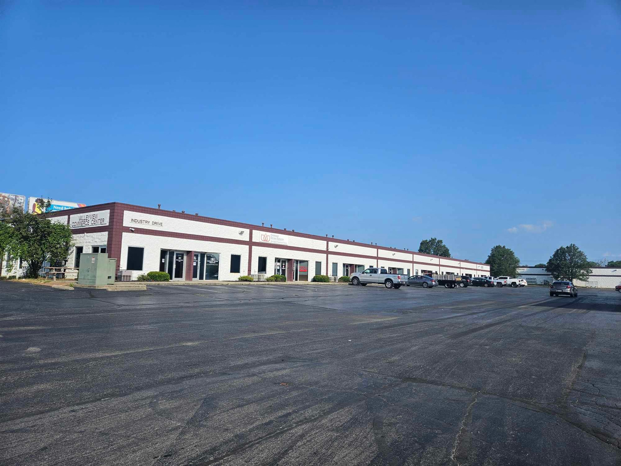 an empty parking lot in front of a building