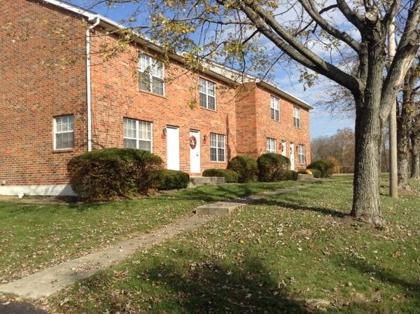 a brick building with a tree in front of it