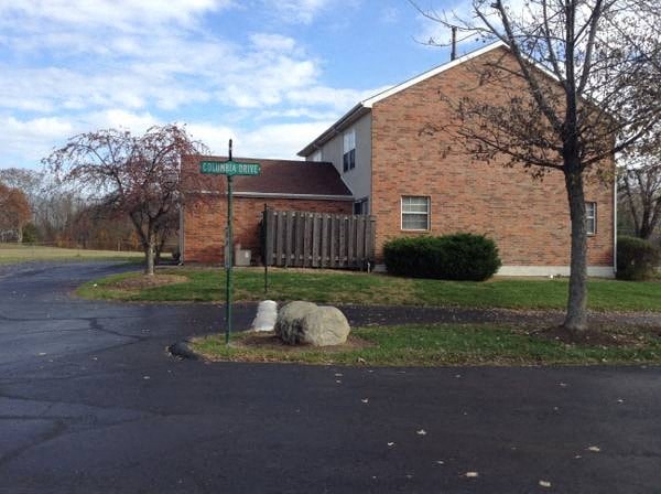 a street sign in front of a brick building