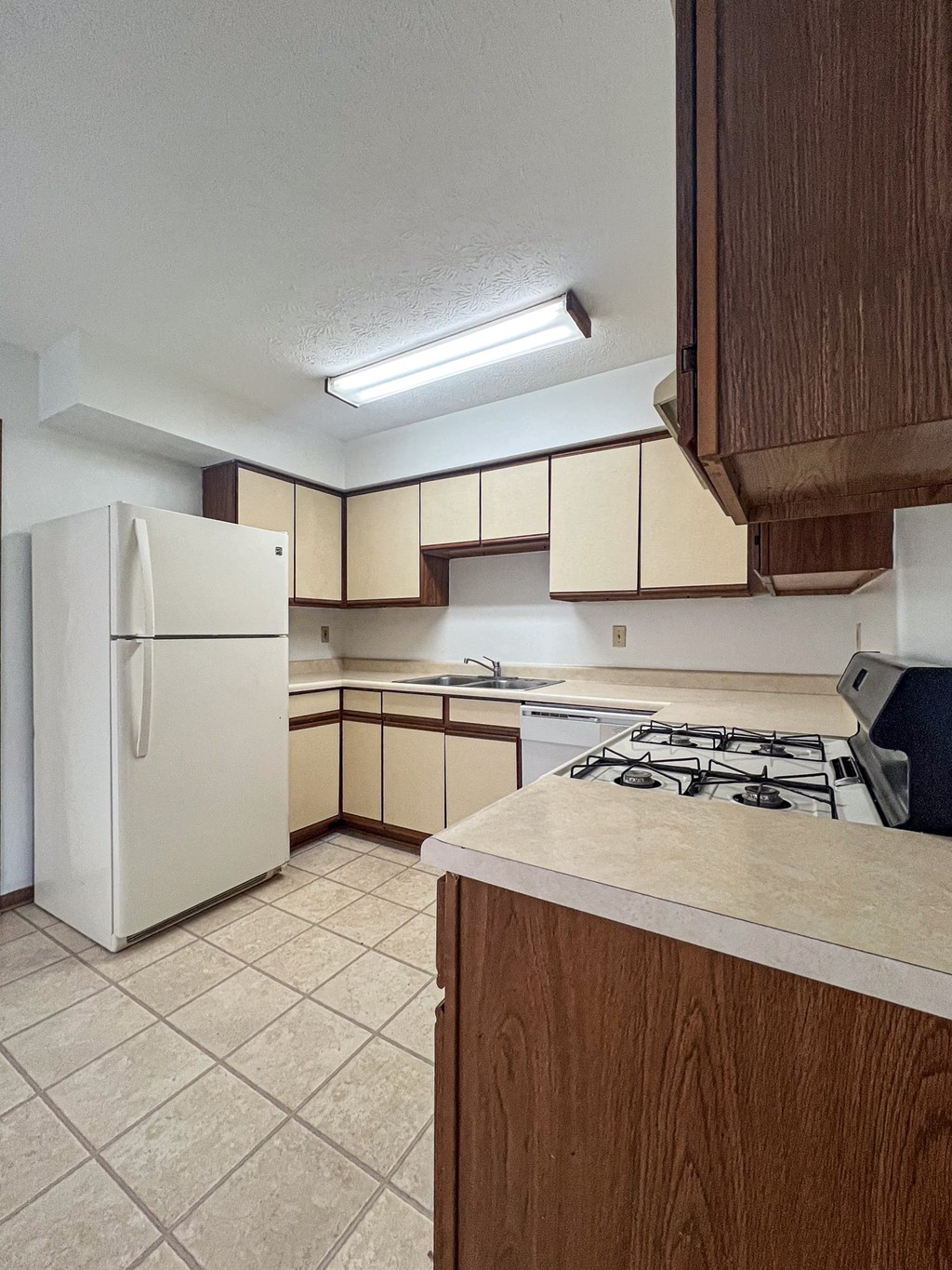 a kitchen with a stove and a refrigerator
