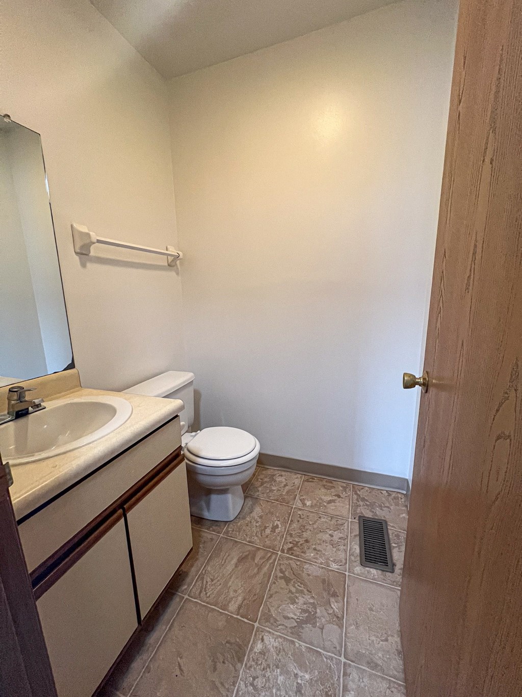 an empty bathroom with a toilet and a sink