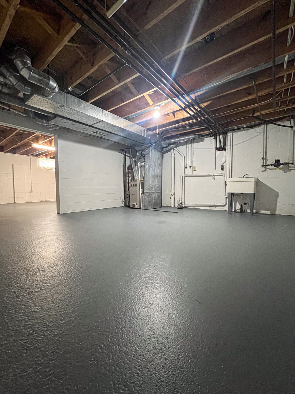 a large room with a white wall and a projector on the ceiling
