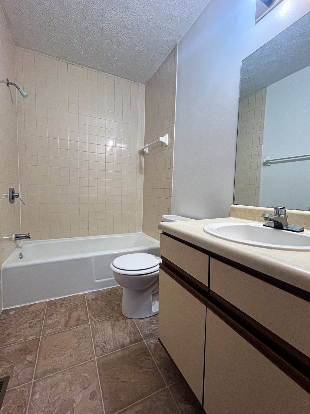 a bathroom with a toilet and a sink and a tub