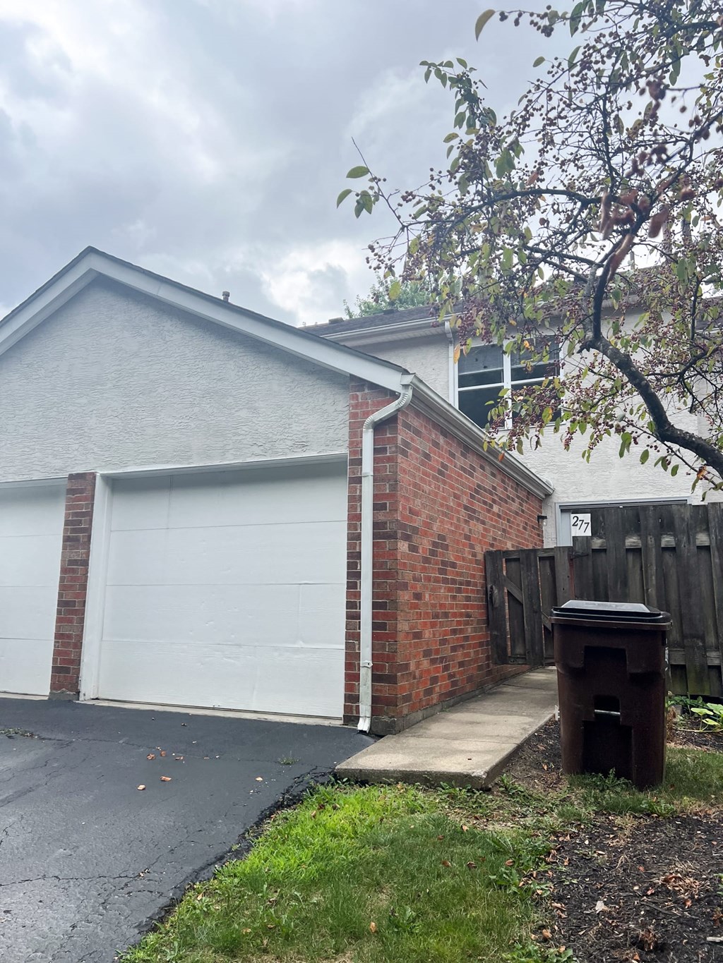 a house with a white garage door and a sidewalk