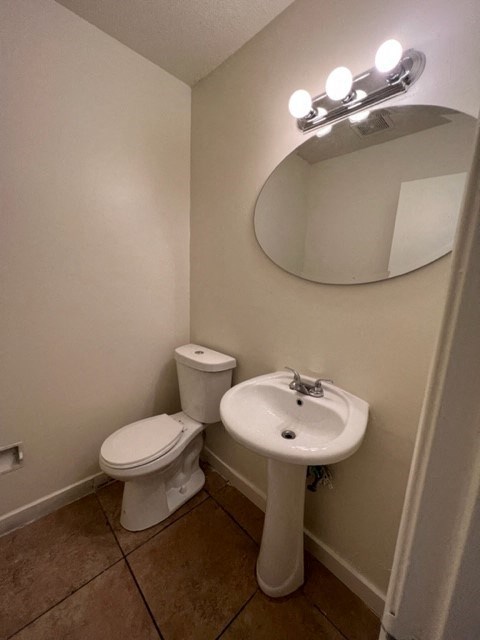 a bathroom with a sink and a toilet and a mirror