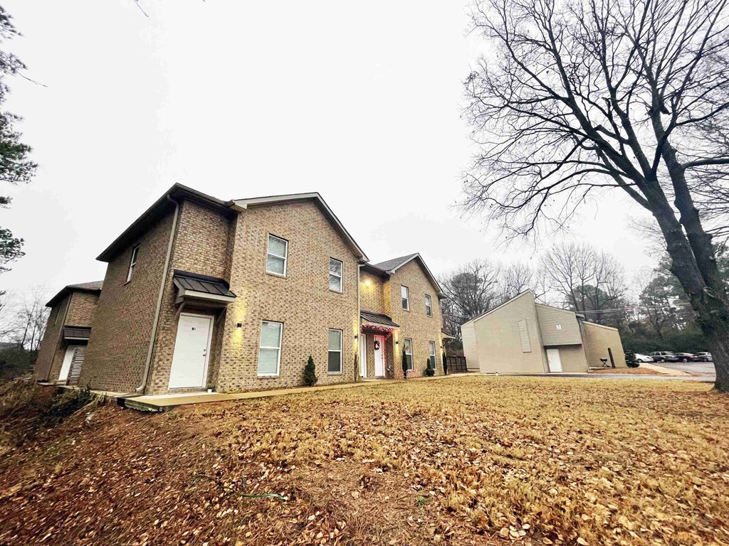 a group of houses on the side of a field