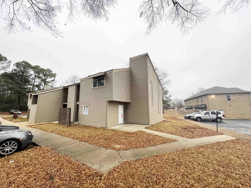 the exterior of a house with a parking lot