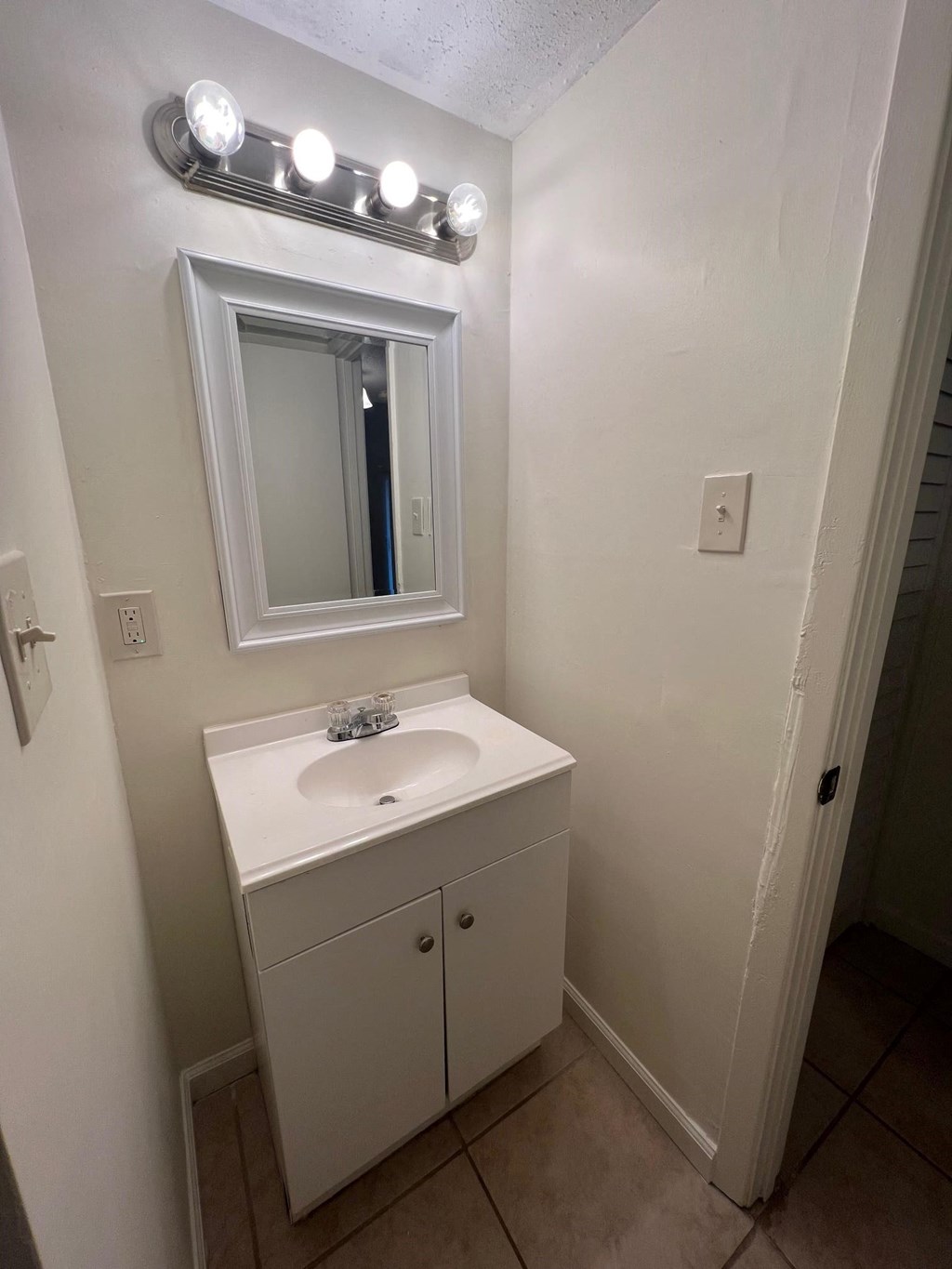a small bathroom with a sink and a mirror