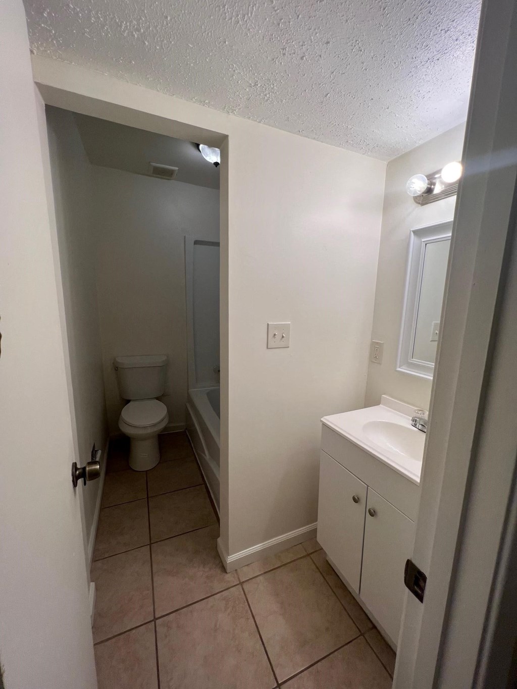 an empty bathroom with a toilet and a sink