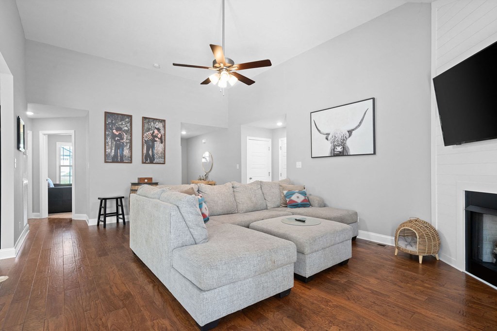 a living room with a couch and a ceiling fan
