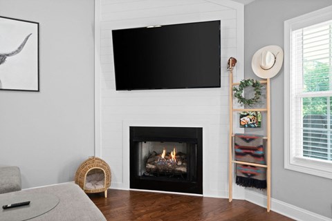 a fireplace with a tv above it in a living room