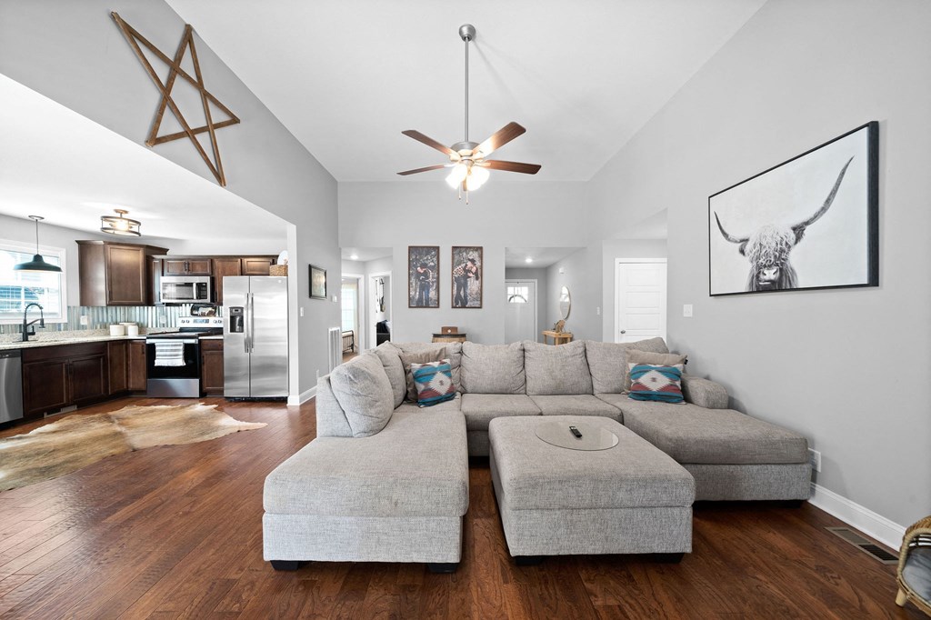 a living room with a couch and a ceiling fan