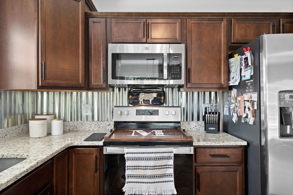 a kitchen with stainless steel appliances and wooden cabinets