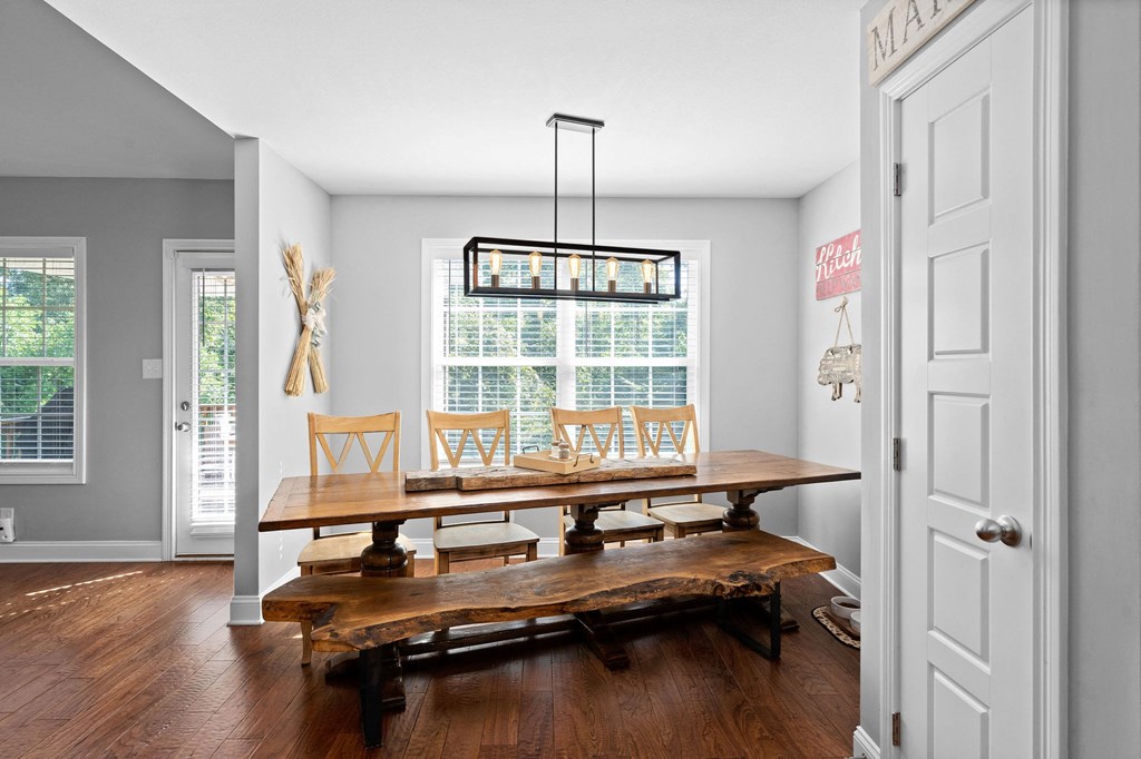 a dining room with a table and chairs and a window