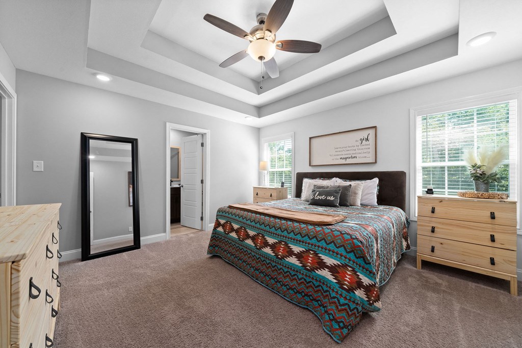 a bedroom with a bed and a ceiling fan