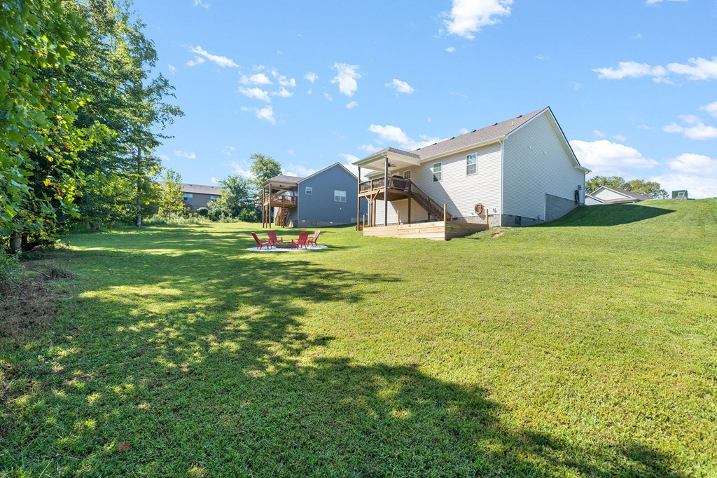 a large yard with a house and a picnic table