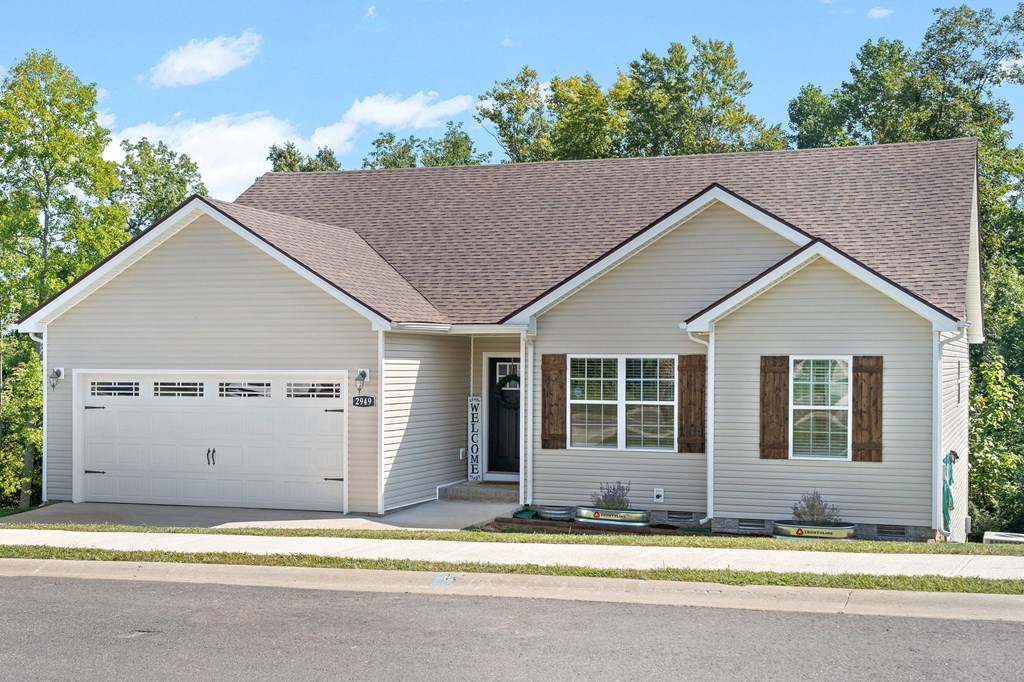 a white house with a garage and a driveway