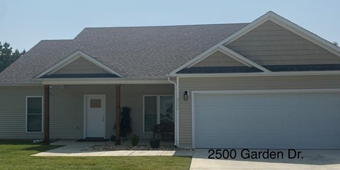 a home with a front porch and a garage door