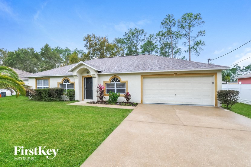 A house with a white garage door is for sale.