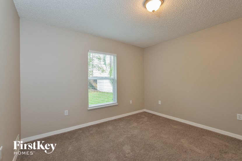 A room with a window showing a tree outside.