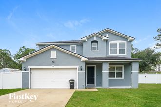 a blue house with a white garage door