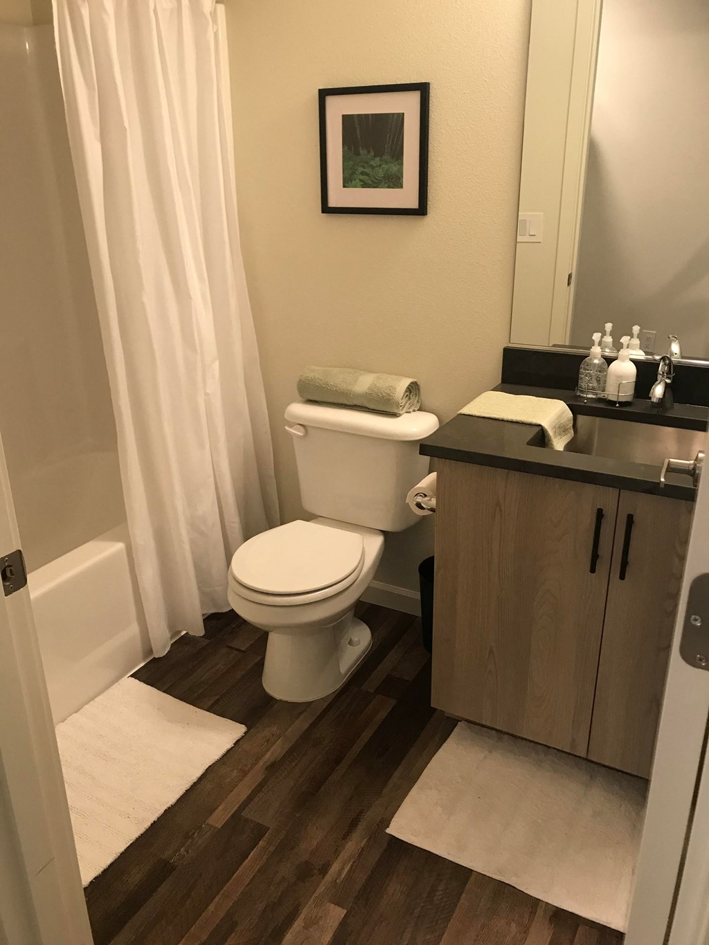 a bathroom with a toilet and a sink and a shower