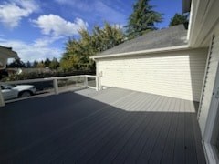 A wooden deck with a white garage door in the background.