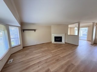 A room with a fireplace and wooden floors.