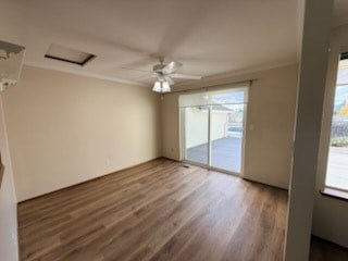 A room with wooden flooring and a ceiling fan.