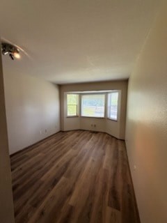 A room with wooden floors and a window.