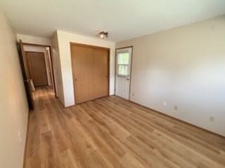 A room with a brown door and a window.