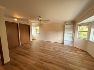 A room with wooden flooring and a ceiling fan.