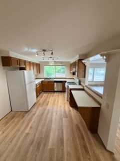 A kitchen with wooden floors and white appliances.
