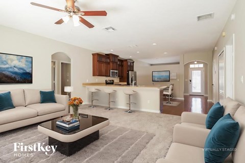 A living room with a white couch and a coffee table.