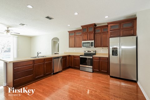 A kitchen with wooden cabinets and stainless steel appliances.