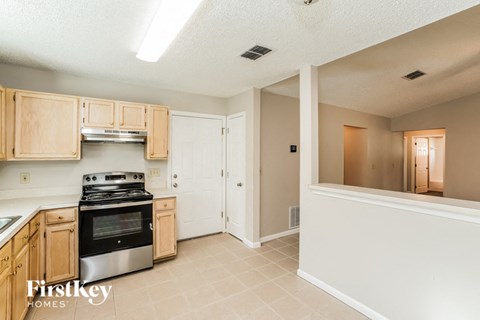 A kitchen with wooden cabinets and a stainless steel oven.