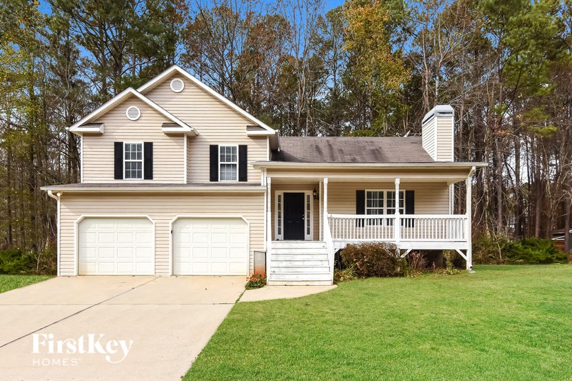 A two-story house with a porch and a garage.