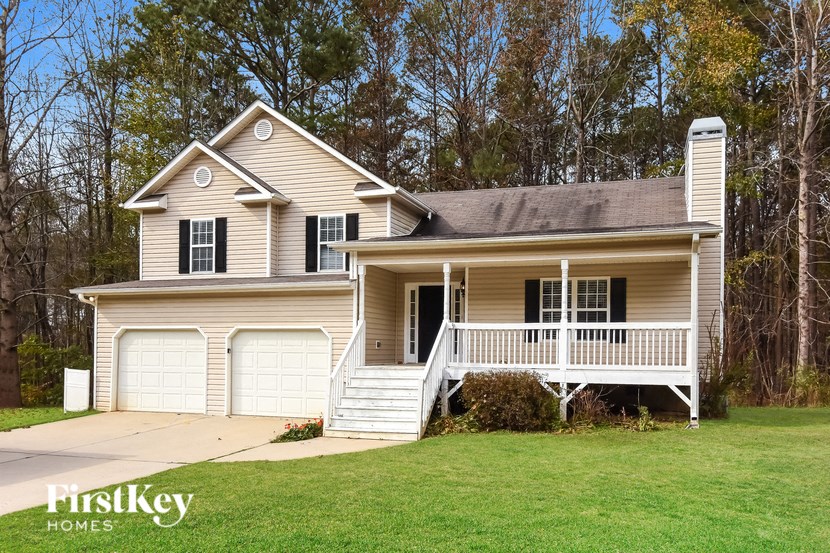 A two-story house with a porch and a garage.